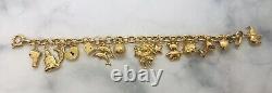 7 1/2 9ct Yellow Gold 13 Charms Bracelet weight 16.57 grams value £1,080 Boxed
