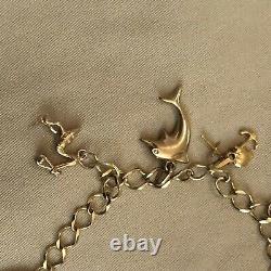 9 carat gold charm bracelet and 9 Charms