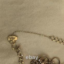 9 carat gold charm bracelet and 9 Charms