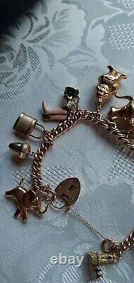 9ct Gold Charm Bracelet with 15 charms. WEIGHS a heavy 42 grs