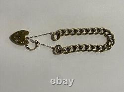 9ct Gold Heavy embossed link charm bracelet with safety chain and padlock 25.8g