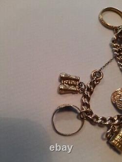 9ct gold charm bracelet with 10 9ct gold charms used