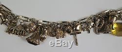 9ct gold charm bracelet with 22 charms. 41.3gms (35.6gms 9ct)