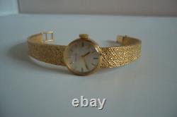 9ct gold ladies Garrard mechanical watch on 9ct bracelet strap, 21gms, used