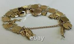 An early 9CT Solid Gold & Thirteen Charm Bracelet 21.40g / 20cm