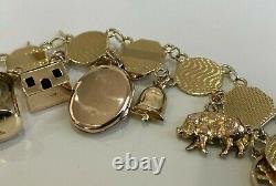 An early 9CT Solid Gold & Thirteen Charm Bracelet 21.40g / 20cm