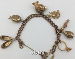 Hallmarked 9ct gold bracelet & seven charms. Weight approx. 32.5g