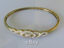 Secondhand 9ct yellow gold multi diamond crossover hinged bangle/bracelet (9.8g)