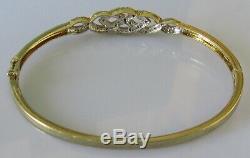 Secondhand 9ct yellow gold multi diamond crossover hinged bangle/bracelet (9.8g)