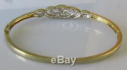 Secondhand 9ct yellow gold multi diamond crossover hinged bangle/bracelet (9.8g)