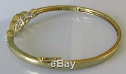 Secondhand 9ct yellow gold multi diamond crossover hinged bangle/bracelet (9.8g)