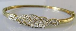 Secondhand 9ct yellow gold multi diamond crossover hinged bangle/bracelet (9.8g)