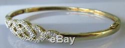 Secondhand 9ct yellow gold multi diamond crossover hinged bangle/bracelet (9.8g)