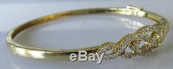 Secondhand 9ct yellow gold multi diamond crossover hinged bangle/bracelet (9.8g)