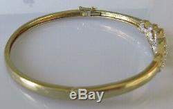 Secondhand 9ct yellow gold multi diamond crossover hinged bangle/bracelet (9.8g)