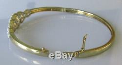 Secondhand 9ct yellow gold multi diamond crossover hinged bangle/bracelet (9.8g)