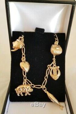 Vintage 9ct Yellow gold bracelet. Suspended from which are Eight 9ct charms