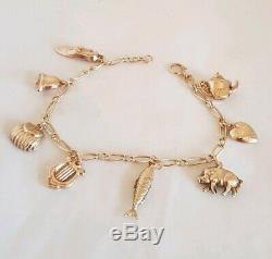 Vintage 9ct Yellow gold bracelet. Suspended from which are Eight 9ct charms