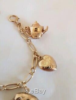 Vintage 9ct Yellow gold bracelet. Suspended from which are Eight 9ct charms