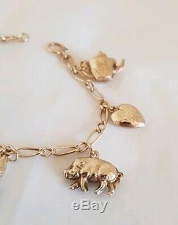 Vintage 9ct Yellow gold bracelet. Suspended from which are Eight 9ct charms